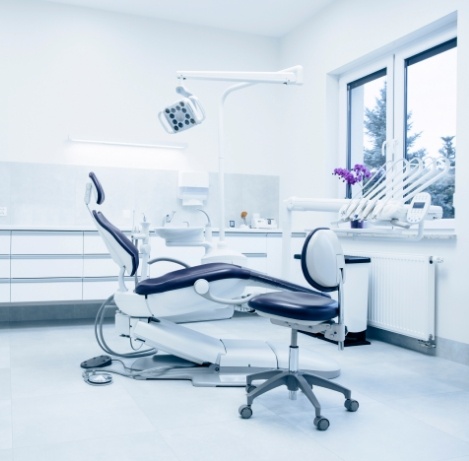 Pristine dental treatment room with white walls