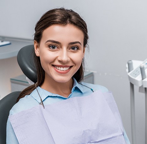 A smiling woman sitting in a dentist’s chair