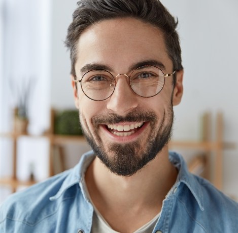 Man in glasses grinning
