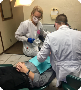 Oklahoma City dentist and assistant treating a dental patient